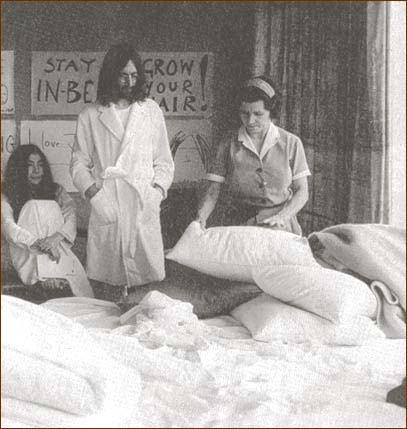John Lennon watches as the bed is made during the Amsterdam Bed-In For Peace.