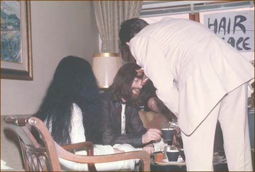 John and Yoko being served tea