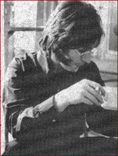 John Lennon enjoys a cup of tea with his muttonchops, circa 1966.